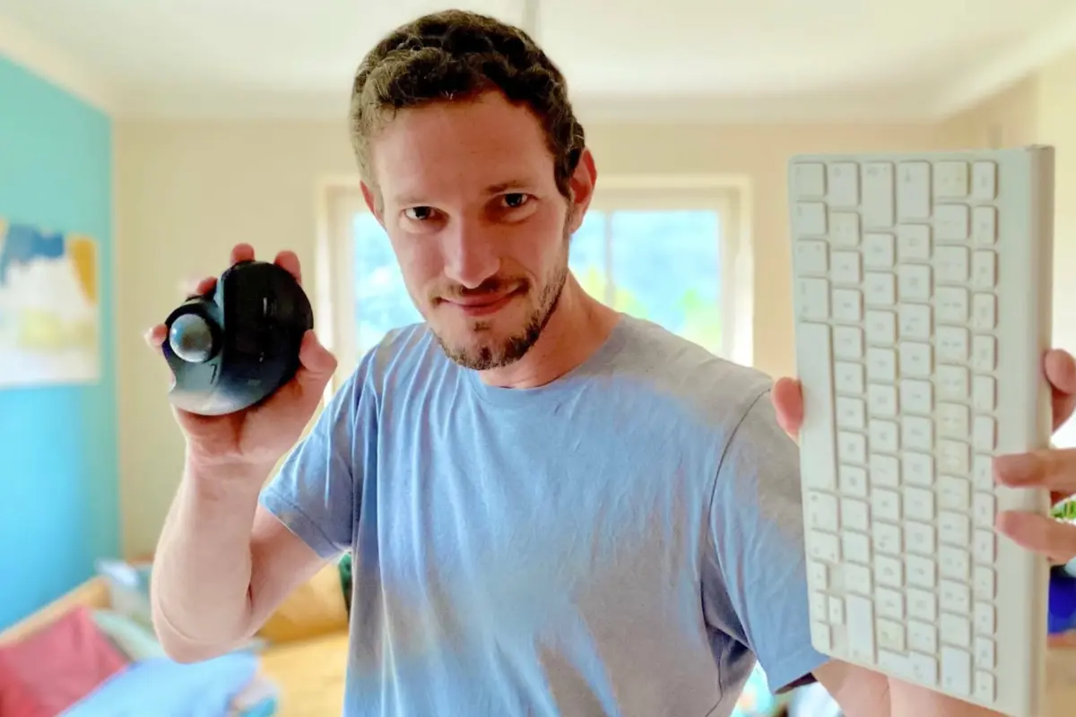 Ben Croker holding a mouse and keyboard.